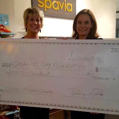 spavia staff with a check for charity