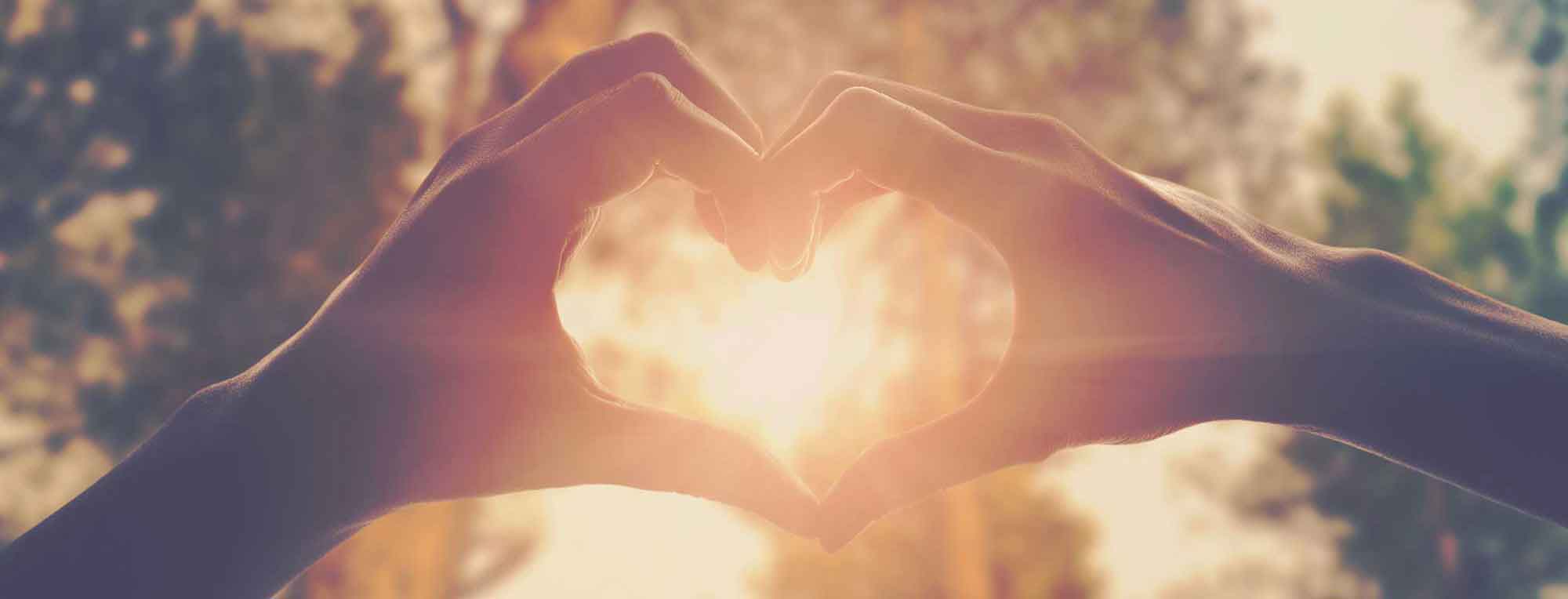 heart hand gesture in the sun