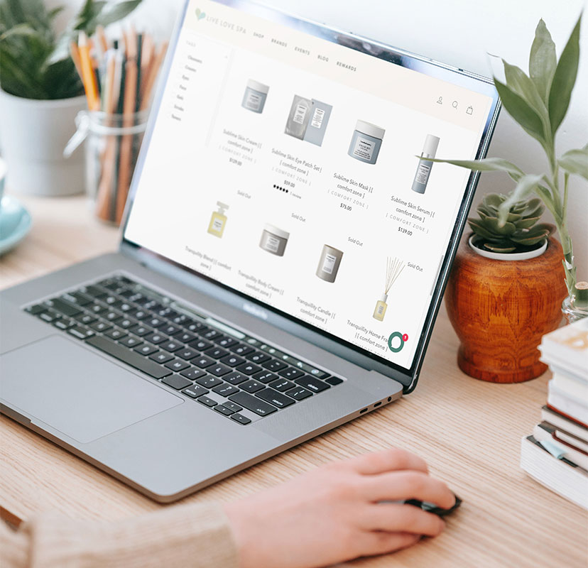 Spavia Day Spa online store on laptop with person using mouse