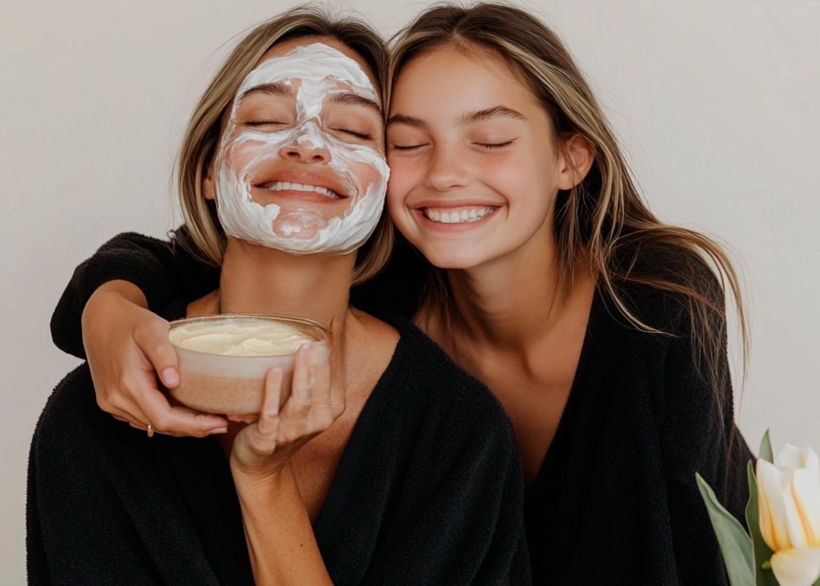 Mother and daughter enjoying a spa facial holding a bowl Mother and daughter enjoying a spa facial holding a bowl